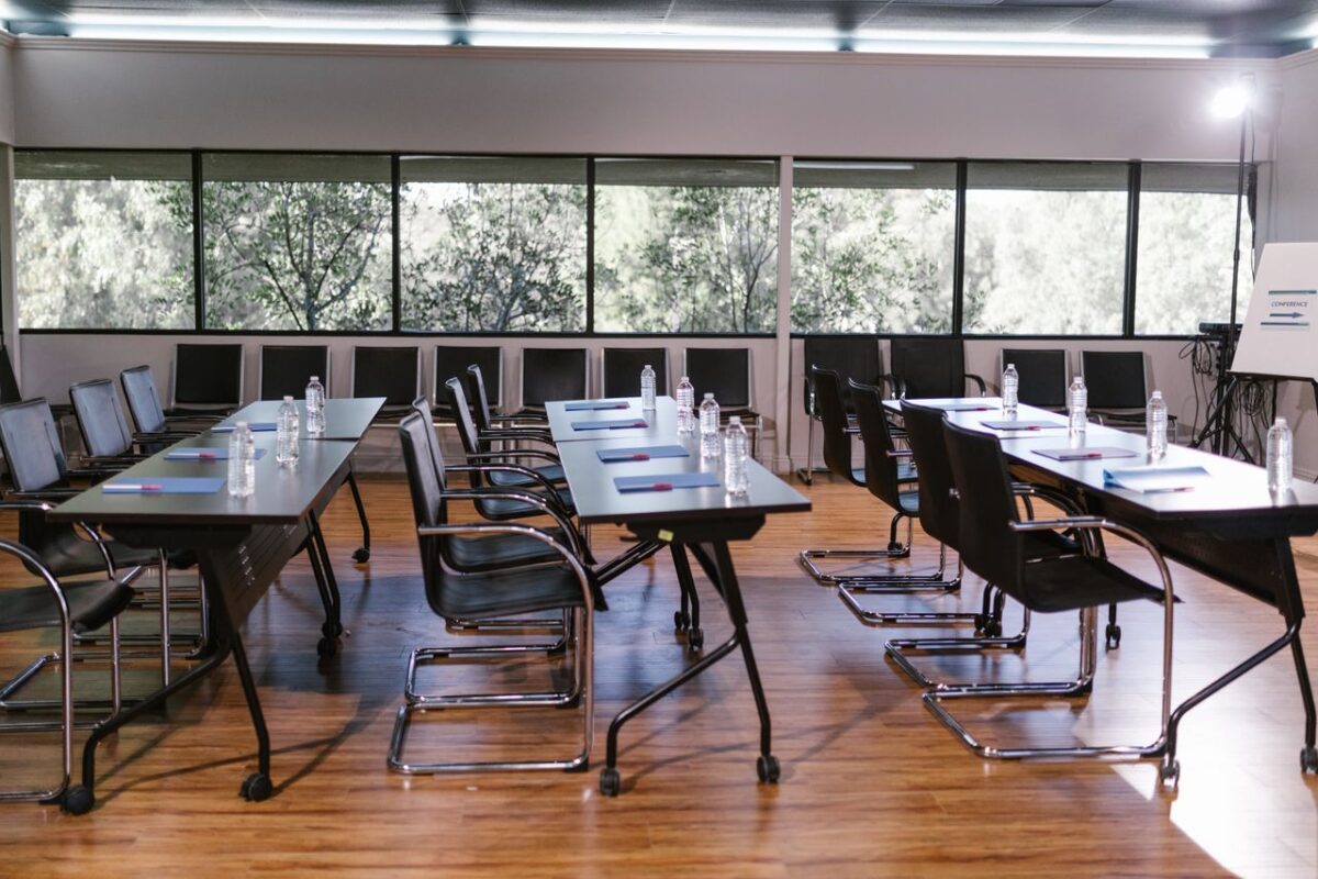 An empty conference room with sleek furniture, ready for a meeting. Bright and professional setting.
